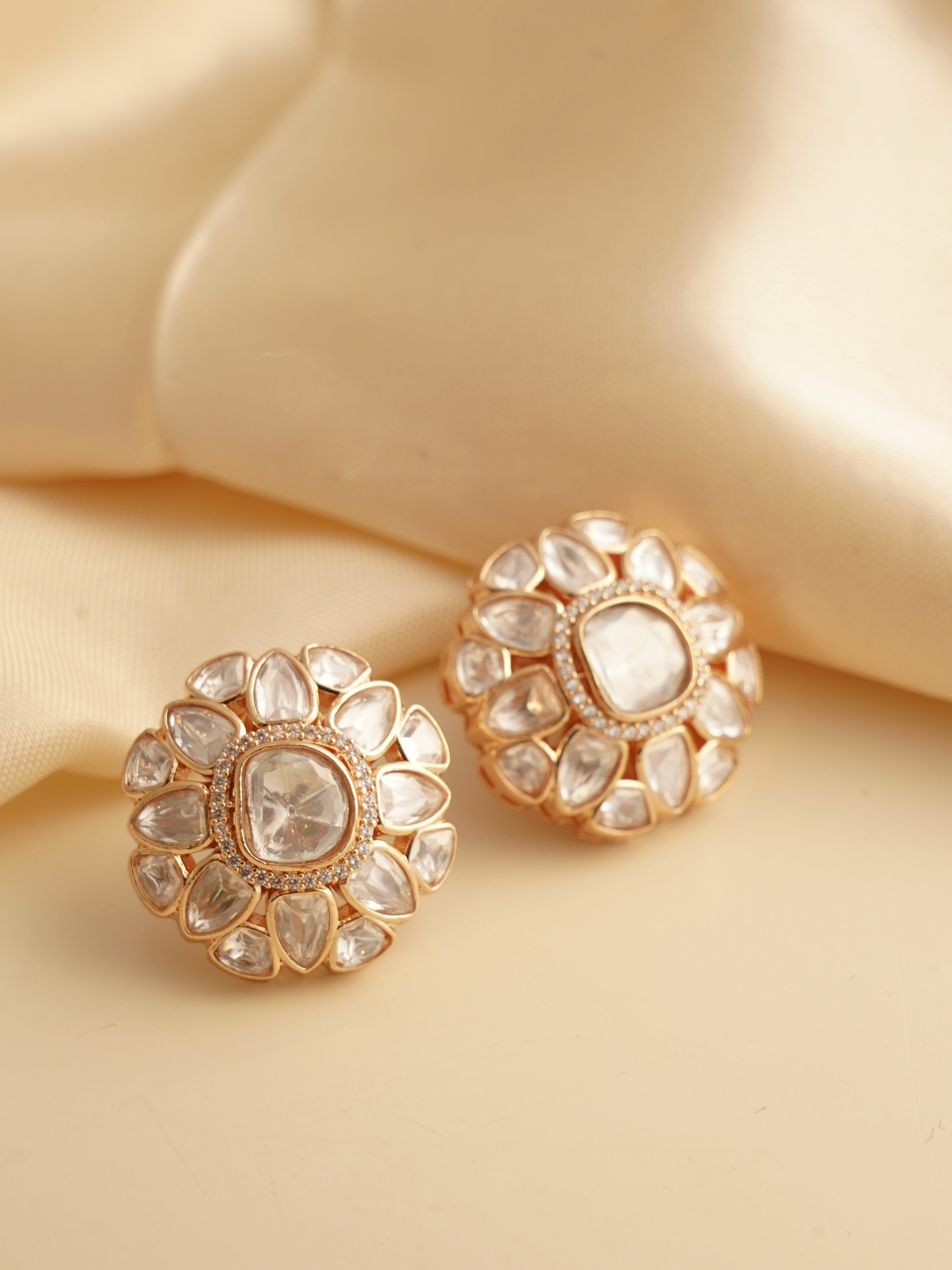 Front view of kundan earrings arranged in a radiant petal-like design with high-shine finish